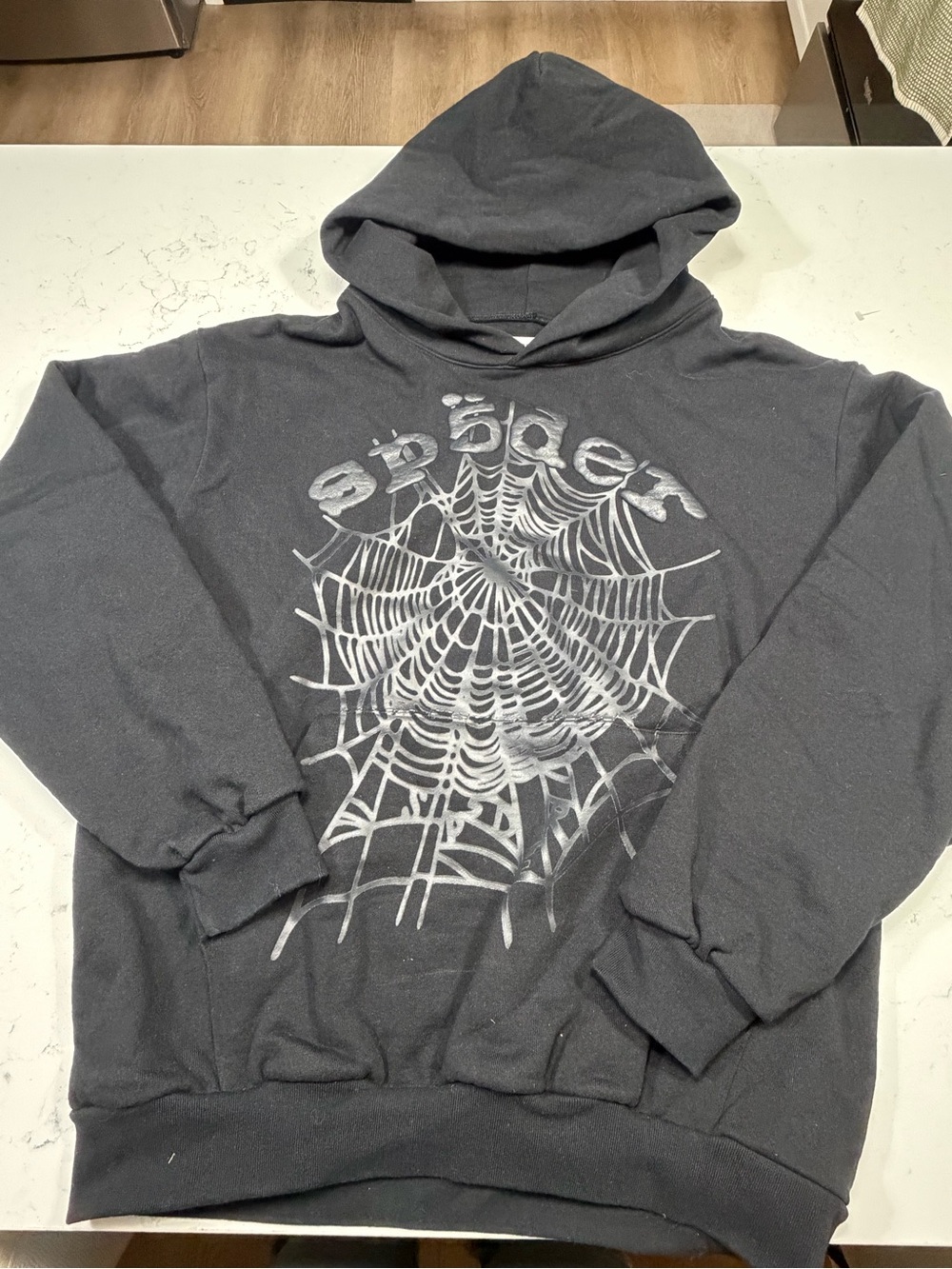 SP5DER Phantom Web Hoodie in black/charcoal with the signature spider-web graphi